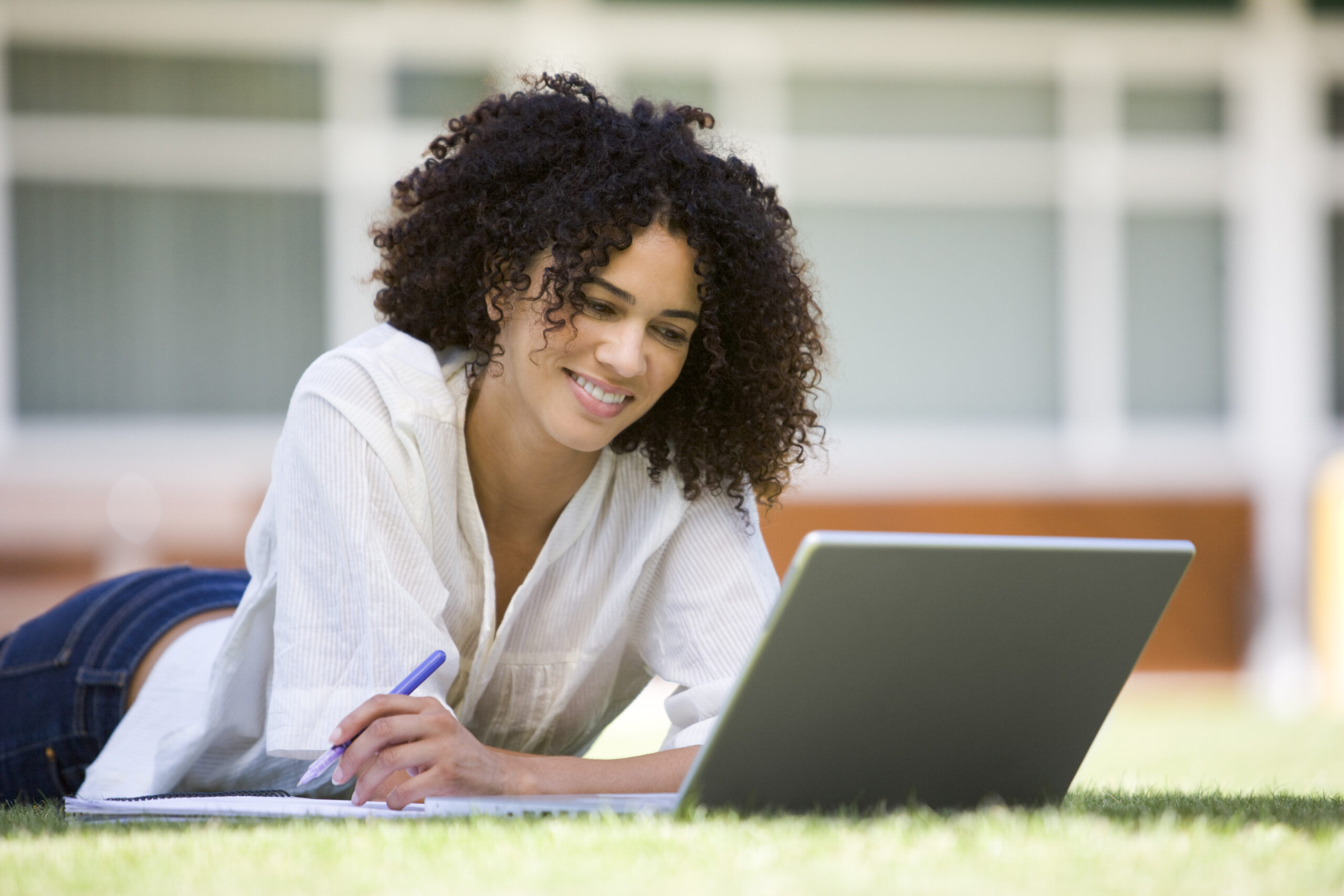 Woman using laptop on campus